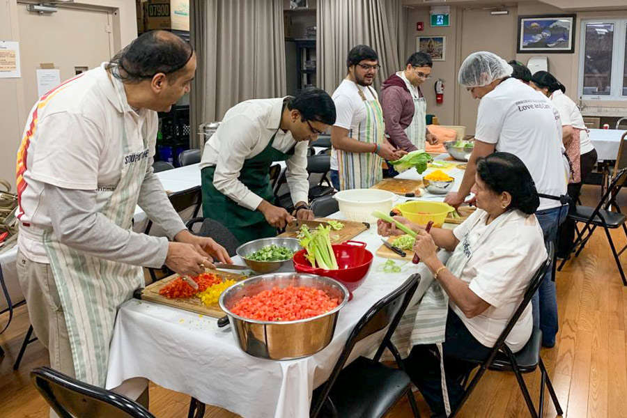 Volunteers in Toronto serve a nutritious Jain meal to homeless adults